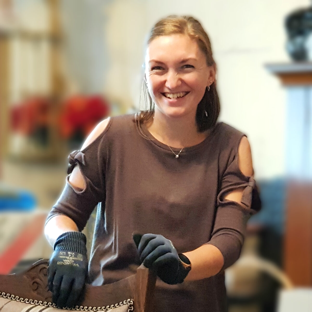 Beth Nixon professional organiser with gloves on smiling at the camera